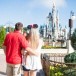 family in front of Cinderella's castle at Disney image