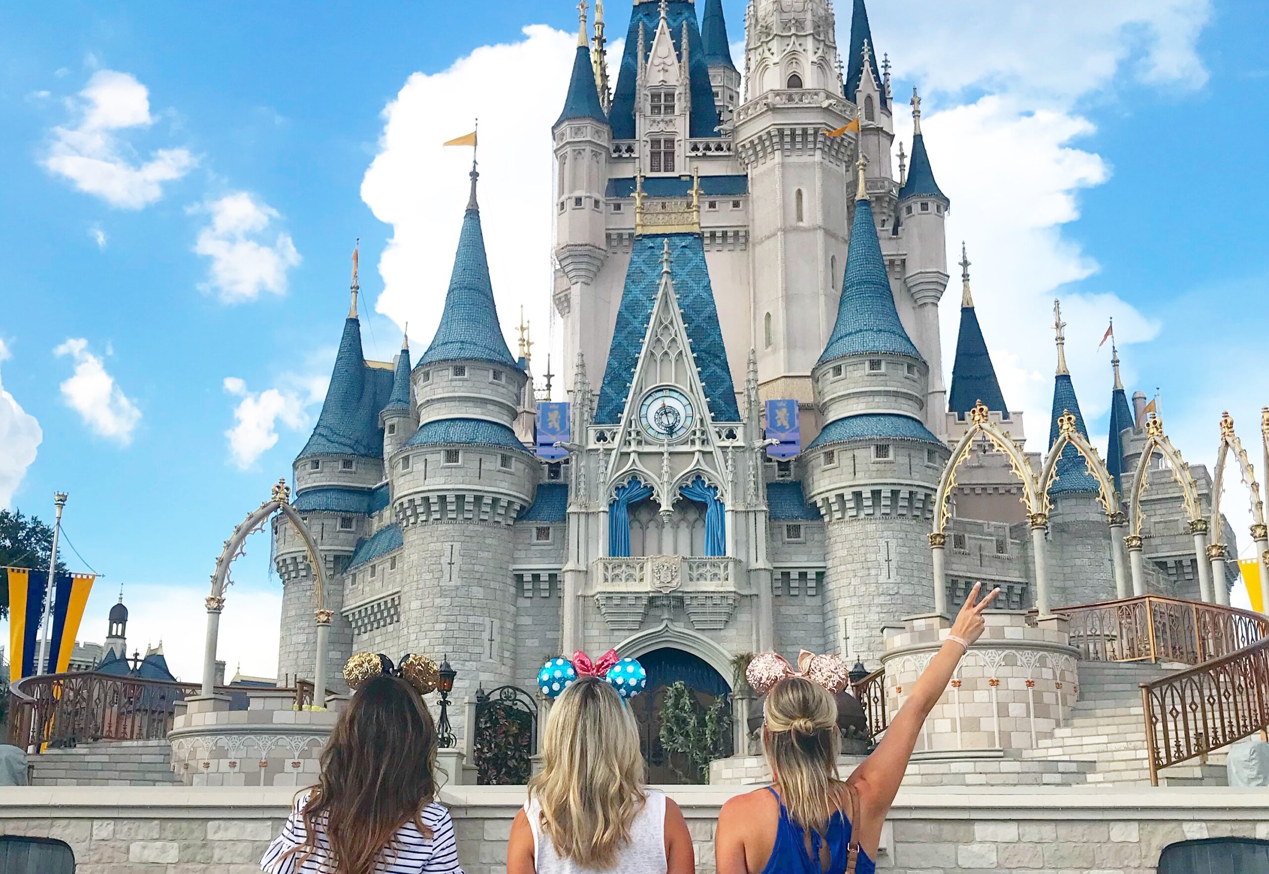 women in front of cinderella's castle image