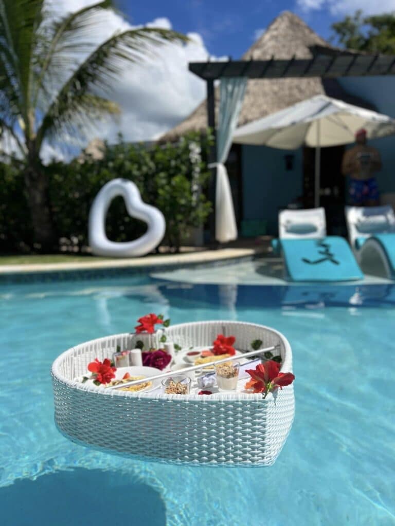 Romantic floating heart-shaped food tray in private pool with butler room service at a Sandals Resorts featuring luxury in-room dining experience in the Caribbean