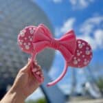 Pink Minnie ears in front of Spaceship Earth at EPCOT in Walt Disney World