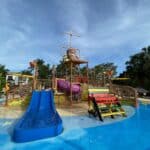 Colorful splash pad and kids water play area at Beaches Negril resort in Jamaica, featuring slides and interactive water features.