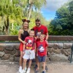 Family wearing Disney-themed outfits enjoying a Disney vacation together