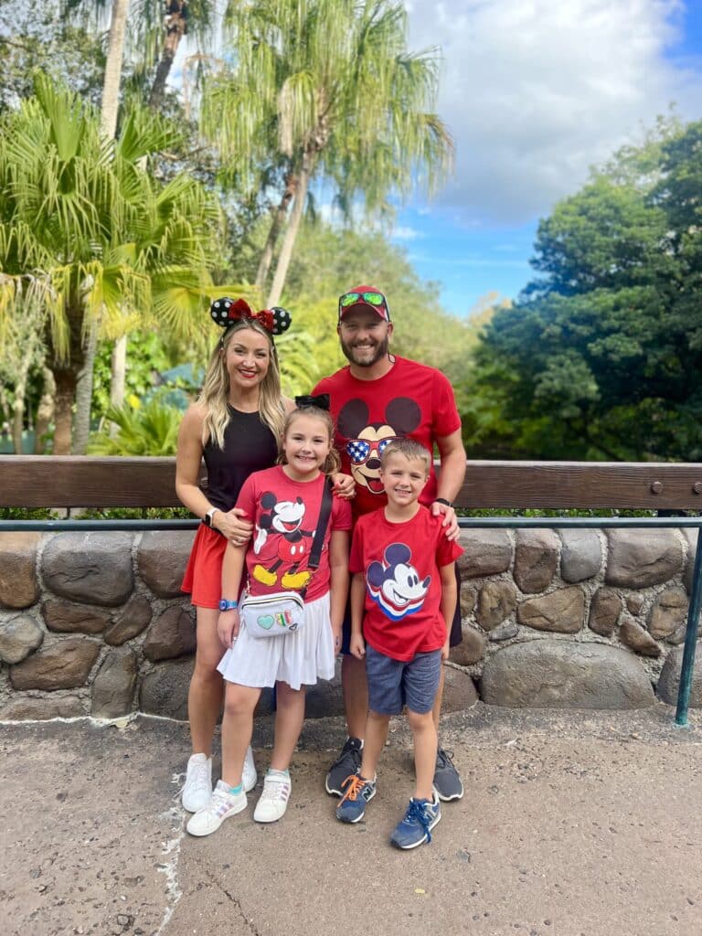Family wearing Disney-themed outfits enjoying a Disney vacation together