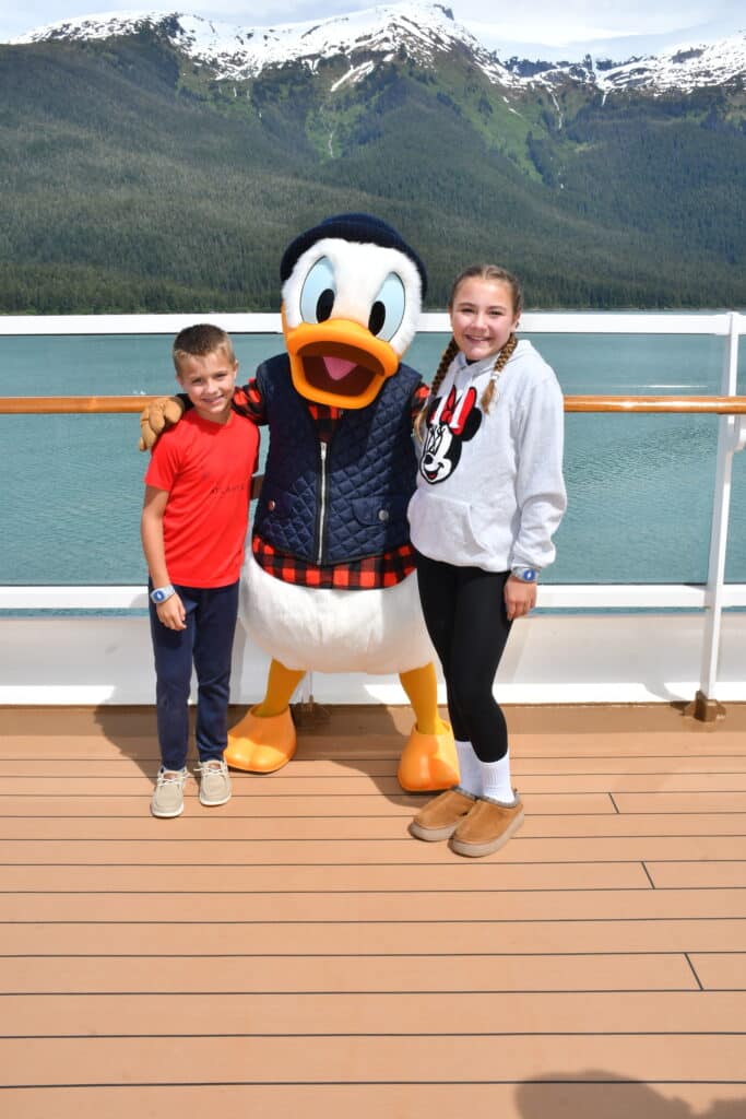 Paisley and Parker meeting Donald Duck in his Alaska outfit on Disney Wonder