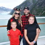 Family enjoying Alaska glacier views from Disney cruise verandah