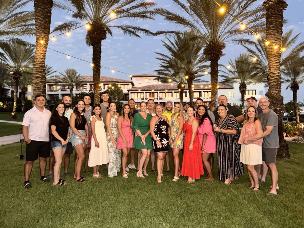 Large group photo of Traveling Ears Vacations 7th annual group trip with friends gathered at a luxury resort in Curaçao.