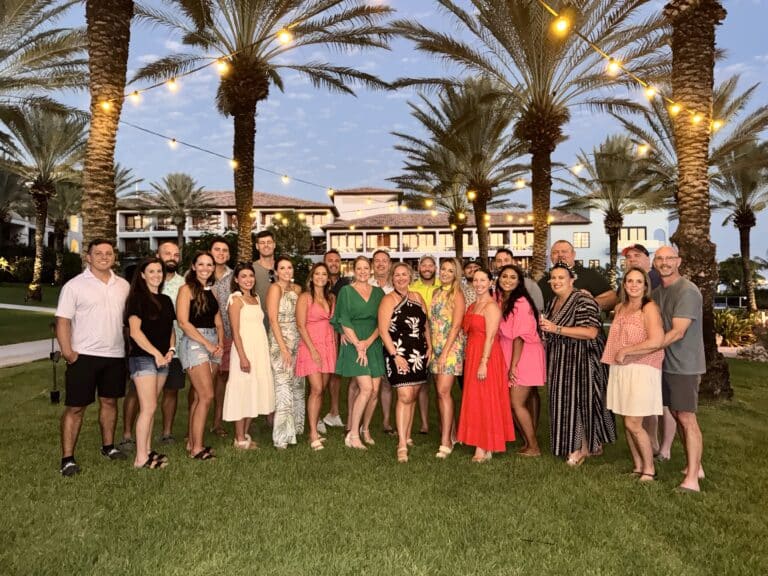 Large group photo of Traveling Ears Vacations 7th annual group trip with friends gathered at a luxury resort in Curaçao.