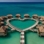 Overwater bungalows at Sandals South Coast featuring luxurious private villas above the Caribbean Sea with glass floors and direct ocean access