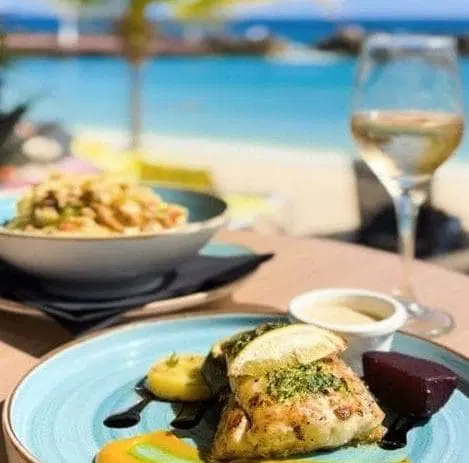 Dining experience at Avila Beach Hotel Curaçao with oceanfront seating and Caribbean cuisine
