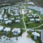 Aerial view of Sandals Saint Vincent resort with beachfront, lush mountains, and turquoise Caribbean water