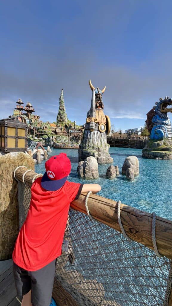 Child looking at Isle of Berk land at Epic Universe in Universal Orlando theme park.