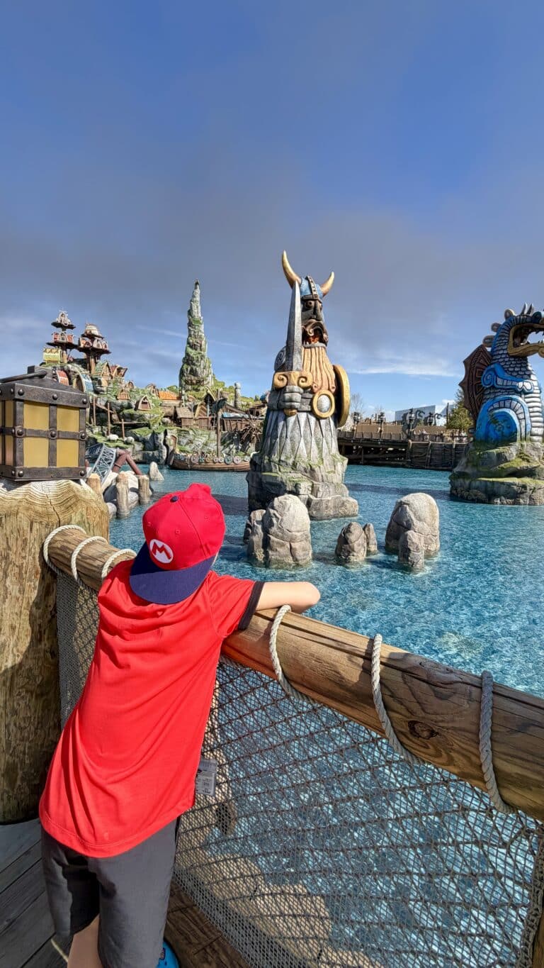 Child looking at Isle of Berk land at Epic Universe in Universal Orlando theme park.