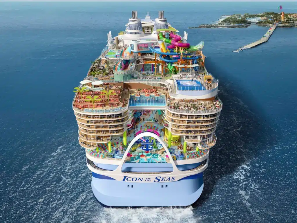 Aerial view of Icon of the Seas showcasing massive ship design, top-deck attractions, and ocean surroundings at sea