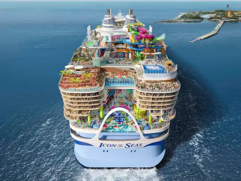 Aerial view of Icon of the Seas showcasing massive ship design, top-deck attractions, and ocean surroundings at sea