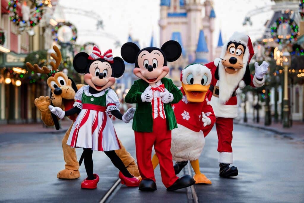 Mickey’s Very Merry Christmas Party characters at Walt Disney World with Mickey, Minnie, and friends in festive holiday outfits during a magical nighttime celebration at Magic Kingdom