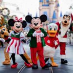 Mickey’s Very Merry Christmas Party characters at Walt Disney World with Mickey, Minnie, and friends in festive holiday outfits during a magical nighttime celebration at Magic Kingdom