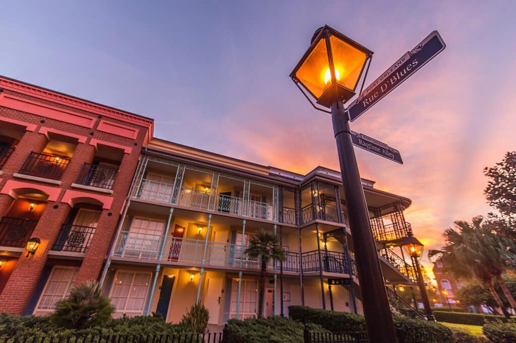 Disney’s Port Orleans French Quarter Resort at Walt Disney World featuring colorful New Orleans-style buildings, cobblestone streets, Mardi Gras theming, the Doubloon Lagoon pool with sea serpent slide, and scenic Sassagoula River views near Disney Springs