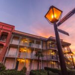 Disney’s Port Orleans French Quarter Resort at Walt Disney World featuring colorful New Orleans-style buildings, cobblestone streets, Mardi Gras theming, the Doubloon Lagoon pool with sea serpent slide, and scenic Sassagoula River views near Disney Springs