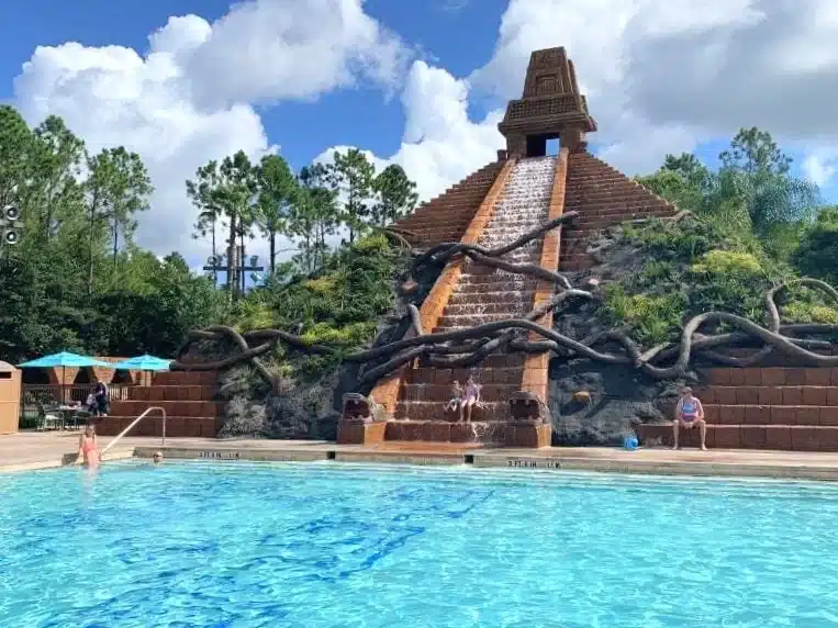Disney’s Coronado Springs Resort pool featuring the Lost City of Cibola at the Dig Site, a Mayan pyramid centerpiece with cascading water, a 123-foot jaguar waterslide, the largest hot tub at Walt Disney World, and additional quiet leisure pools surrounded by lush tropical landscaping