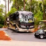 Campsites at Fort Wilderness Campground with RV setup and shaded wooded surroundings