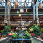 Disney’s Polynesian Village Resort at Walt Disney World featuring tropical South Pacific-inspired architecture, lush palm trees and island landscaping, white-sand beaches along Seven Seas Lagoon, and iconic views of Magic Kingdom with monorail access and overwater bungalows in a deluxe resort setting