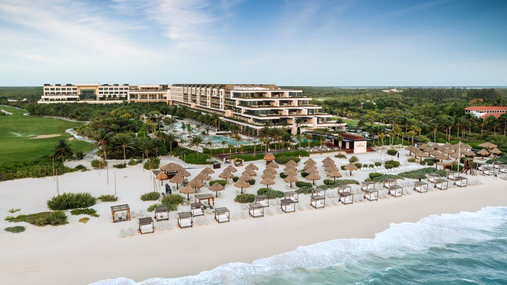 Aerial view of ATELIER Playa Mujeres with the beachfront resort, pools and white-sand beach in Mexico