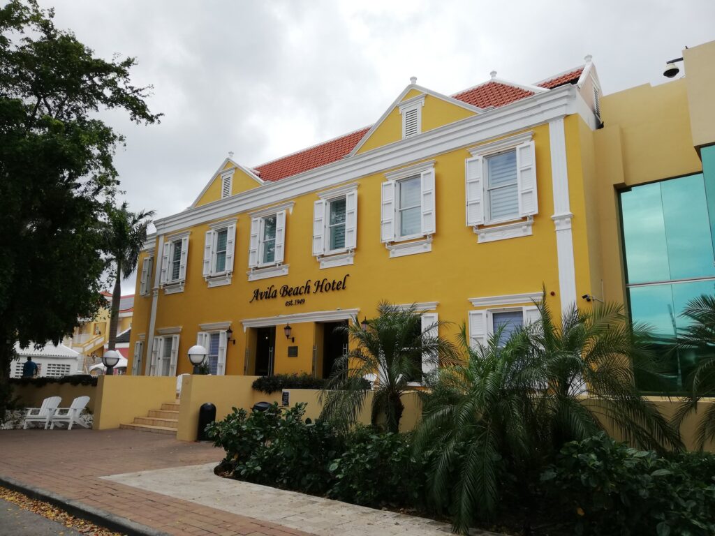 Yellow historic facade of Avila Beach Hotel in Willemstad, Curaçao