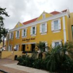 Yellow historic facade of Avila Beach Hotel in Willemstad, Curaçao