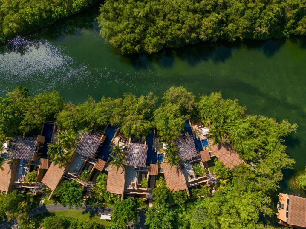 Aerial view of Banyan Tree Mayakoba villas along a winding lagoon through Riviera Maya mangroves
