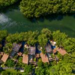 Aerial view of Banyan Tree Mayakoba villas along a winding lagoon through Riviera Maya mangroves
