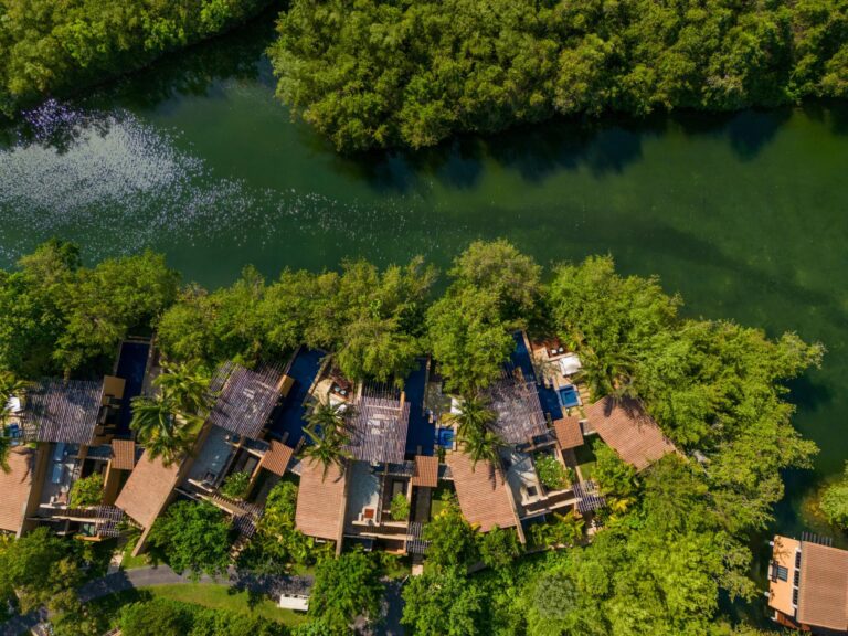 Aerial view of Banyan Tree Mayakoba villas along a winding lagoon through Riviera Maya mangroves