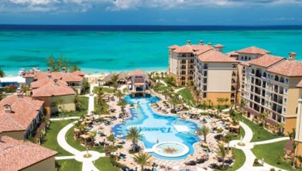 Aerial view of Beaches Turks & Caicos with resort pools, guest buildings and turquoise ocean