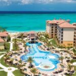 Aerial view of Beaches Turks & Caicos with resort pools, guest buildings and turquoise ocean