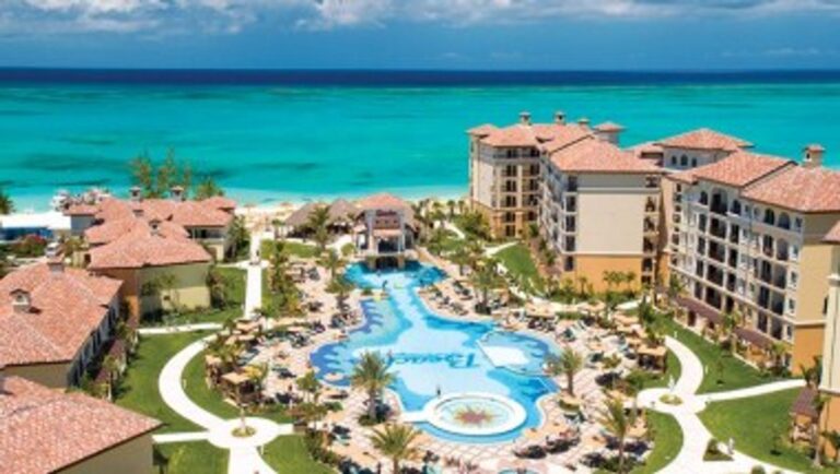 Aerial view of Beaches Turks & Caicos with resort pools, guest buildings and turquoise ocean