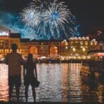 Disney's BoardWalk Resort illuminated at night with fireworks over Crescent Lake