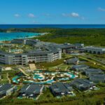 Aerial view of Dreams Macao Beach Punta Cana with resort buildings, pools and water features