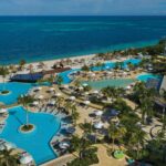 Aerial view of Dreams Natura Resort with multiple pools and the Caribbean beachfront in Riviera Cancun