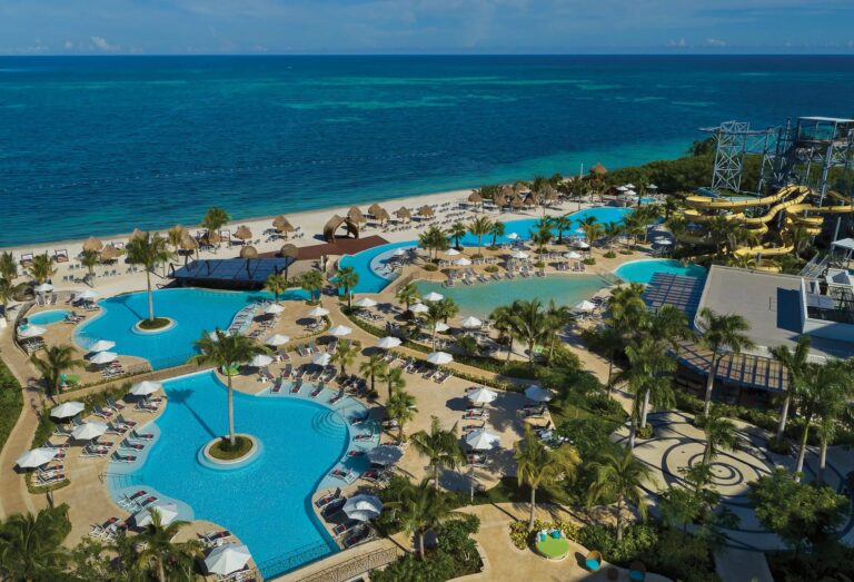 Aerial view of Dreams Natura Resort with multiple pools and the Caribbean beachfront in Riviera Cancun