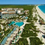 Aerial view of Dreams Playa Mujeres with resort pools, white-sand beach and turquoise Caribbean water in Playa Mujeres, Mexico