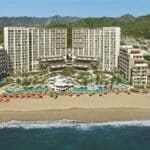 Aerial view of Dreams Vallarta Bay Resort & Spa with the beachfront tower, pools and Pacific shoreline in Puerto Vallarta, Mexico
