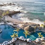 Oceanfront pool complex and rocky Sea of Cortez shoreline at Esperanza Auberge Collection in Los Cabos