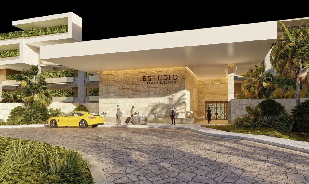 Modern entrance of ESTUDIO Playa Mujeres with resort signage, tropical landscaping and porte cochere in Mexico