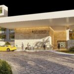 Modern entrance of ESTUDIO Playa Mujeres with resort signage, tropical landscaping and porte cochere in Mexico