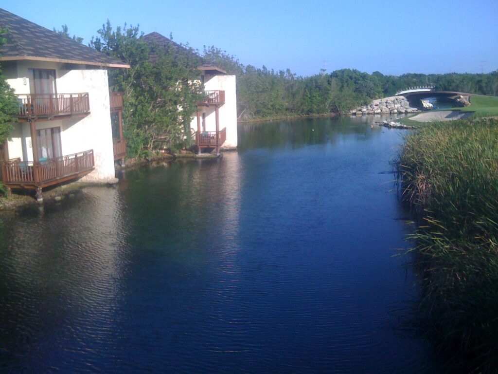 Fairmont Mayakoba casita buildings beside a lagoon and tropical mangroves in Riviera Maya