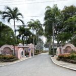 Palm-lined entrance driveway and pink Fairmont Royal Pavilion signs in Barbados