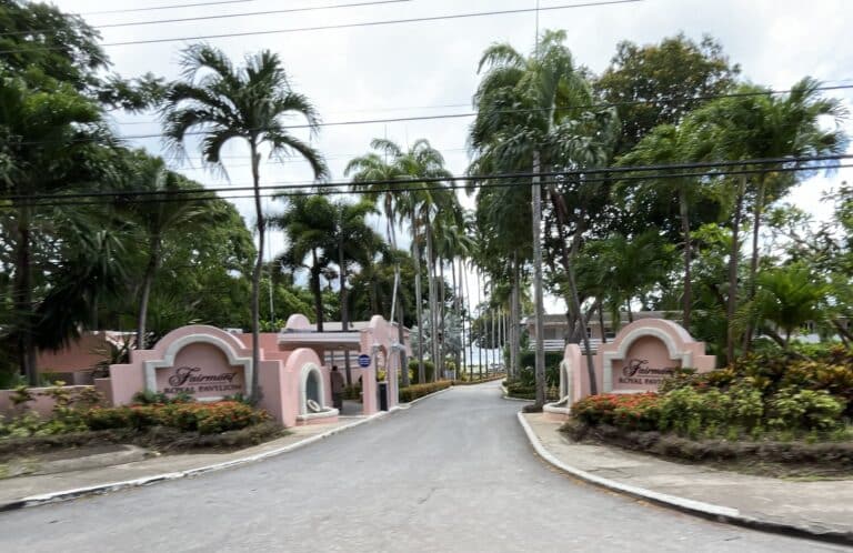 Palm-lined entrance driveway and pink Fairmont Royal Pavilion signs in Barbados