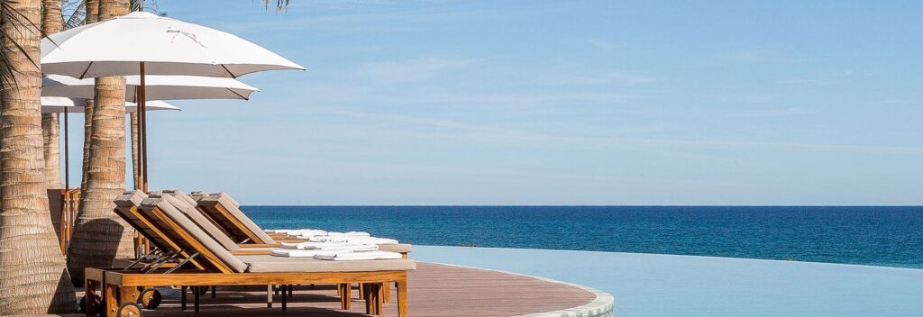 Infinity pool and lounge chairs overlooking the Sea of Cortez at Grand Velas Los Cabos