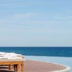 Infinity pool and lounge chairs overlooking the Sea of Cortez at Grand Velas Los Cabos