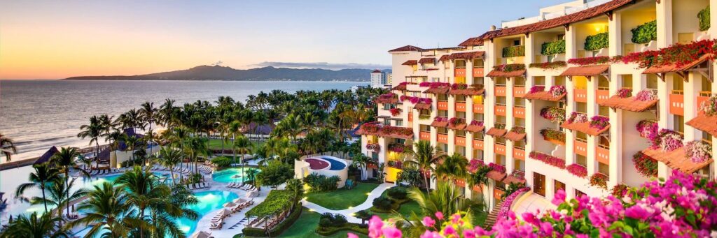 Panoramic view of Grand Velas Riviera Nayarit with pools, tropical gardens, resort buildings and Banderas Bay