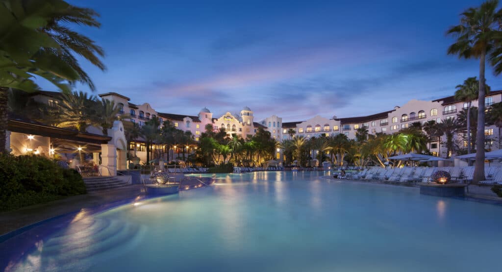 Twilight view of the large resort pool and hotel facade at Hard Rock Hotel at Universal Orlando